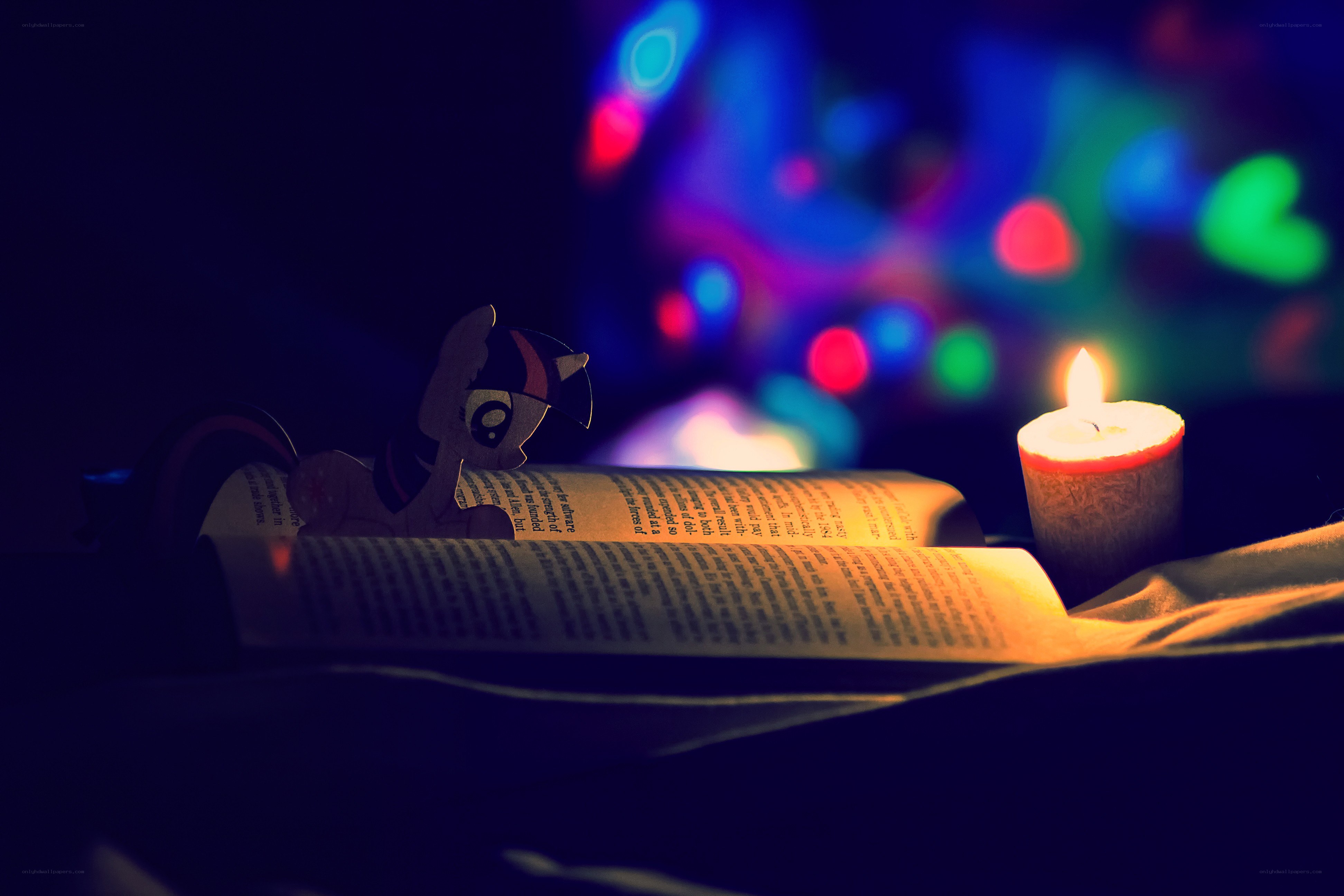 Twilight Sparkle reading by candlelight