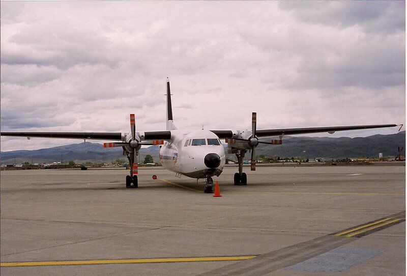 Twin-engine Propeller Plane — Gray, Overcast