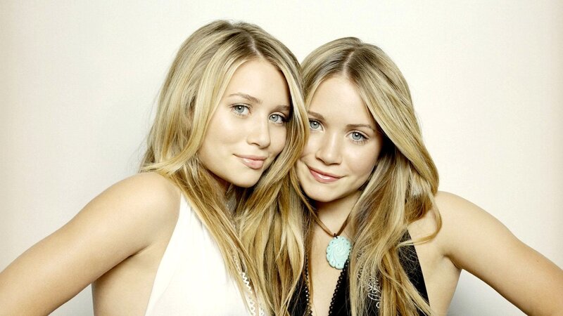 twin sisters posing together