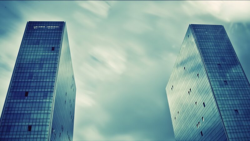 twin skyscrapers against cloudy sky