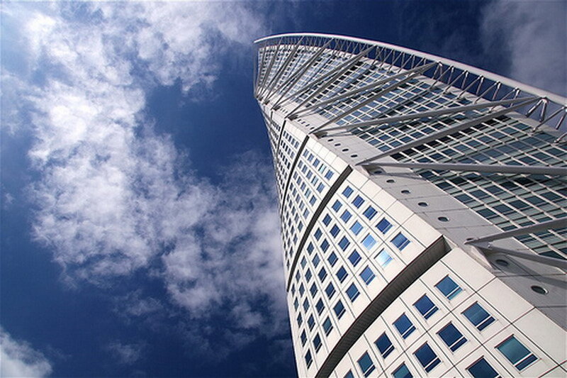 Twisted skyscraper against blue sky