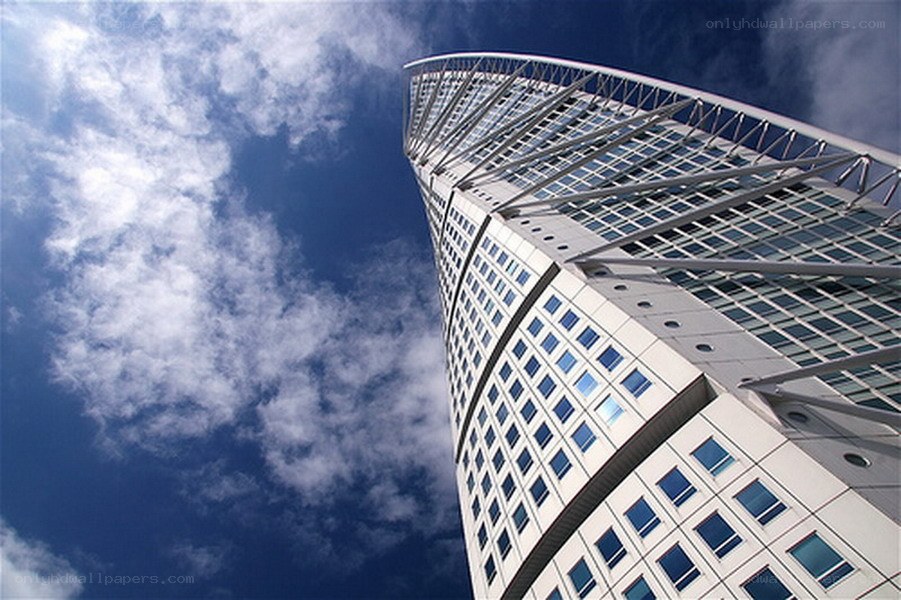 Twisted skyscraper against blue sky