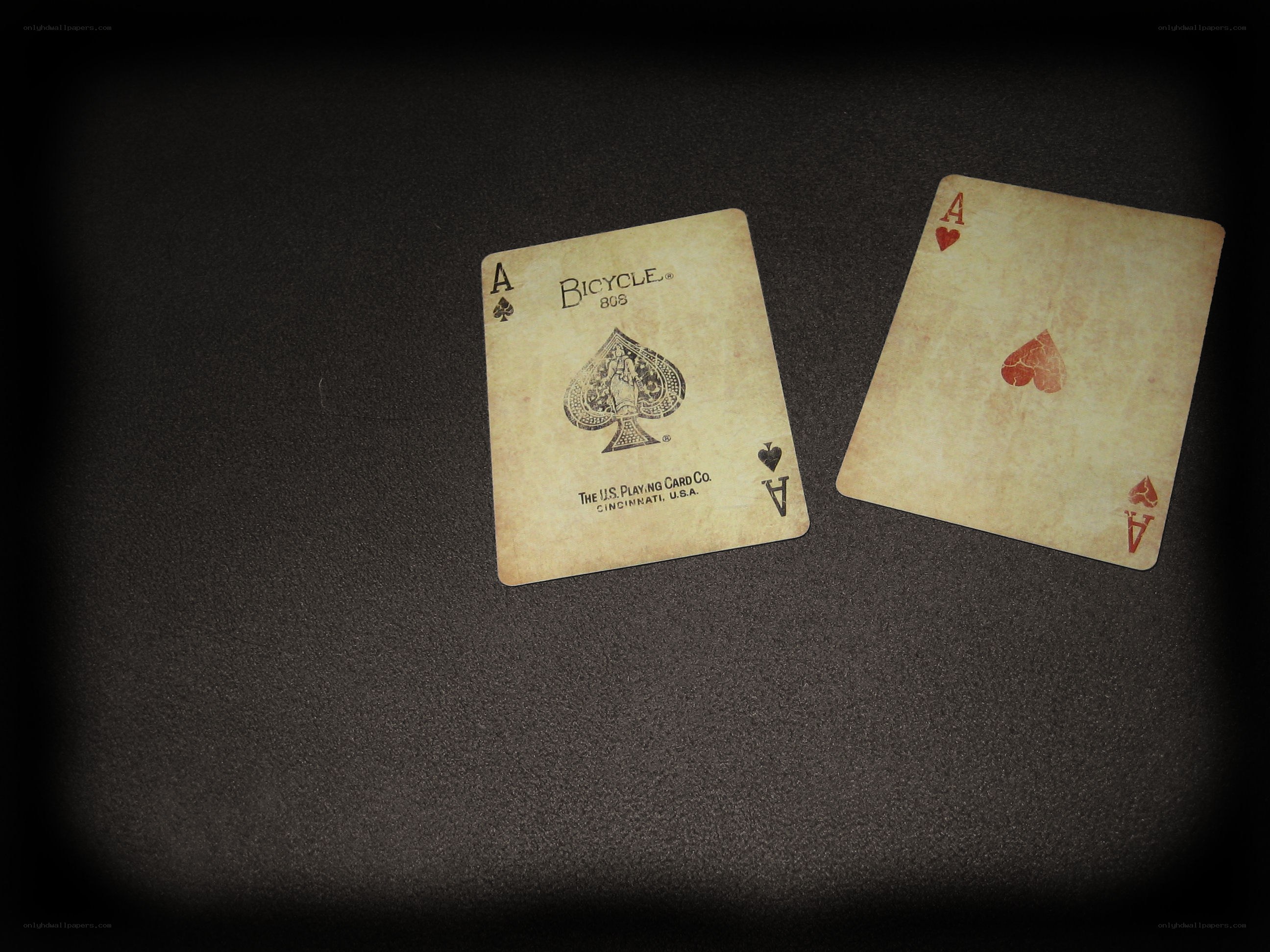 Two aces on dark surface
