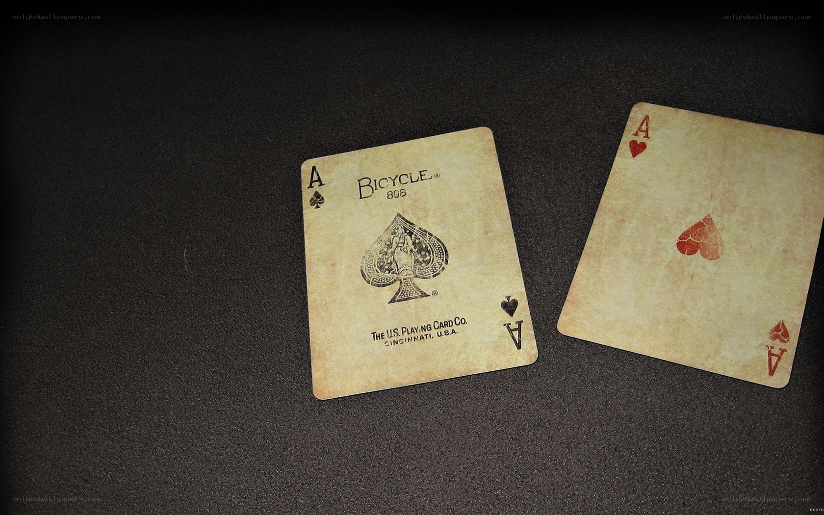 two aces on dark surface