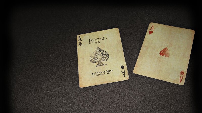 Two aces on dark surface