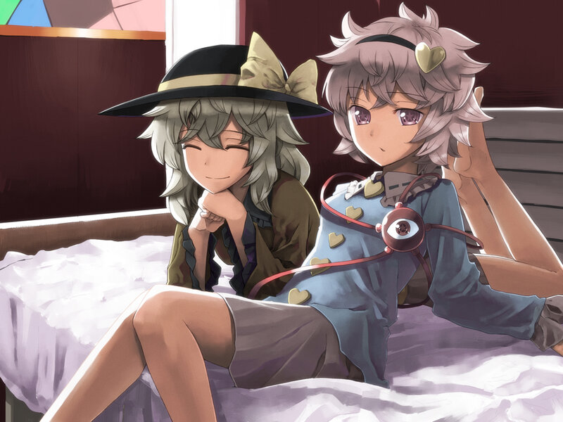 two anime girls on a bed