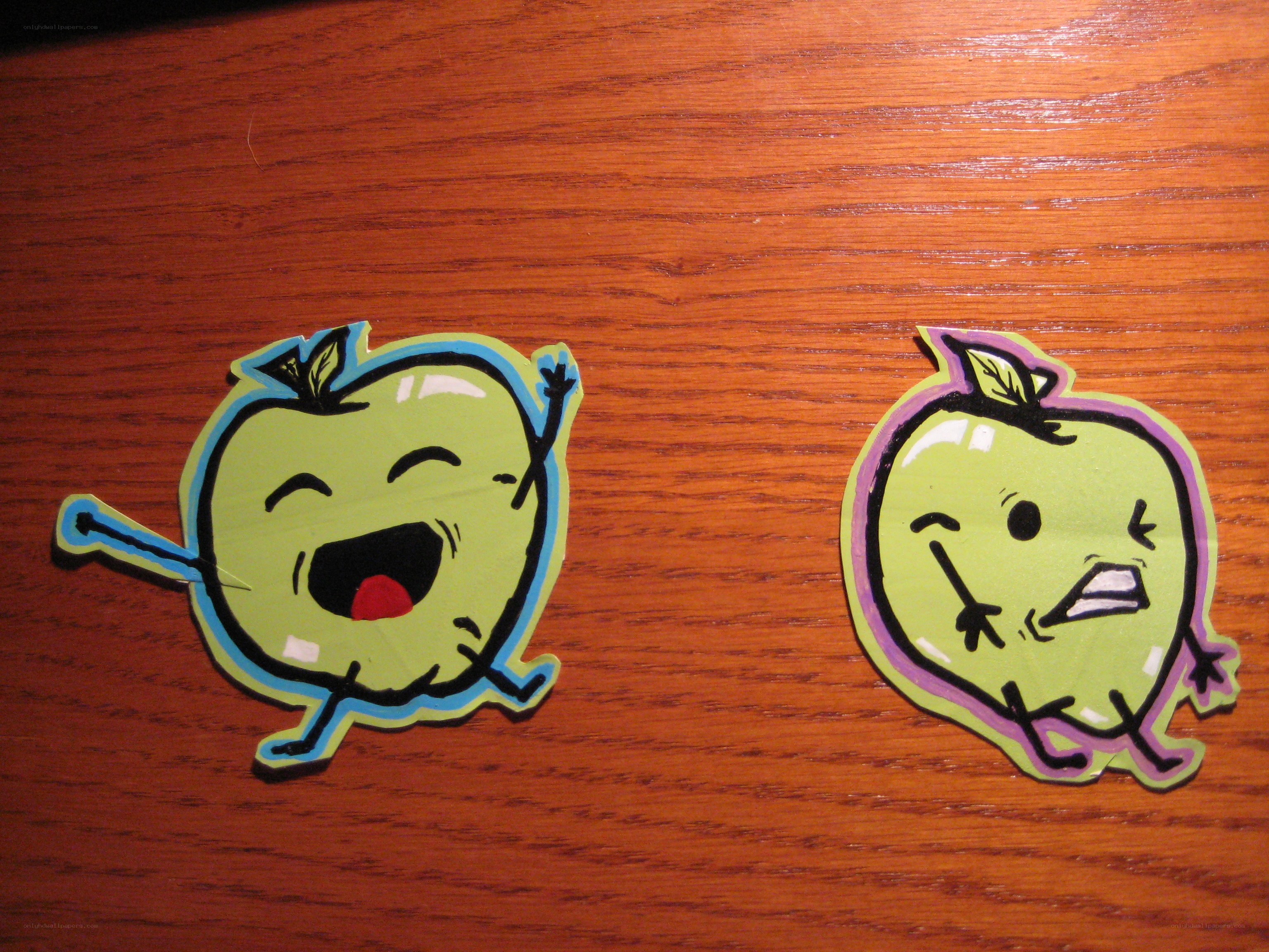 Two apple stickers on wood