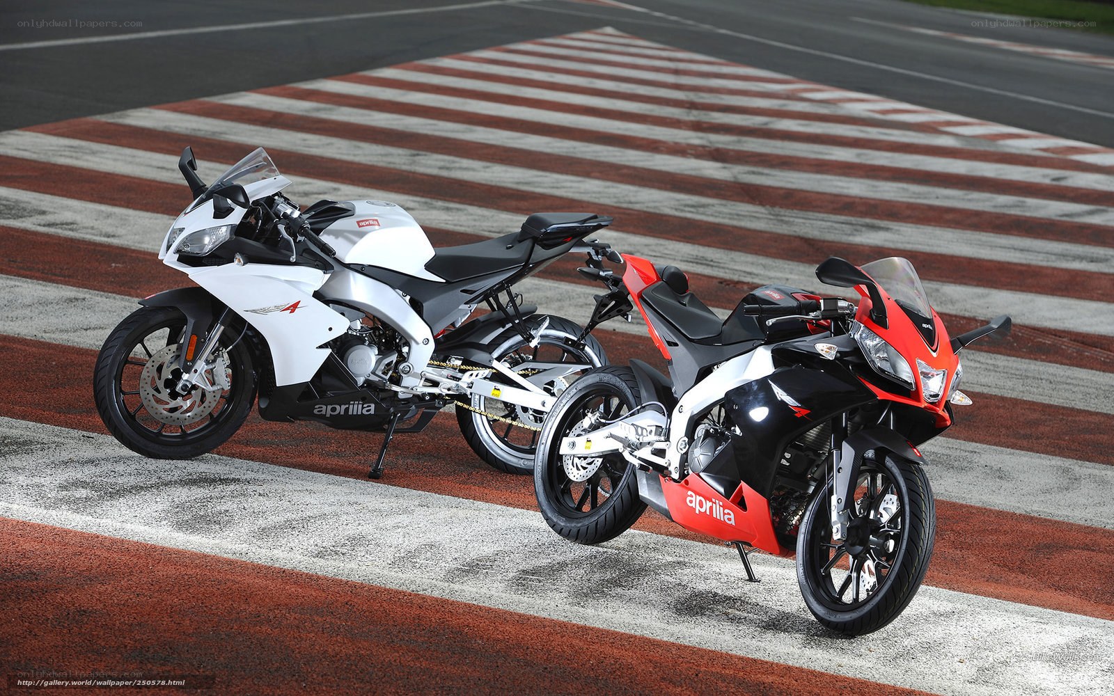 Two Aprilia sport motorcycles on track