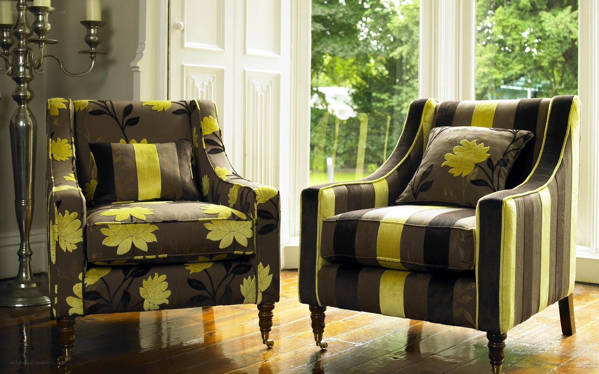 Two armchairs with floral and striped patterns