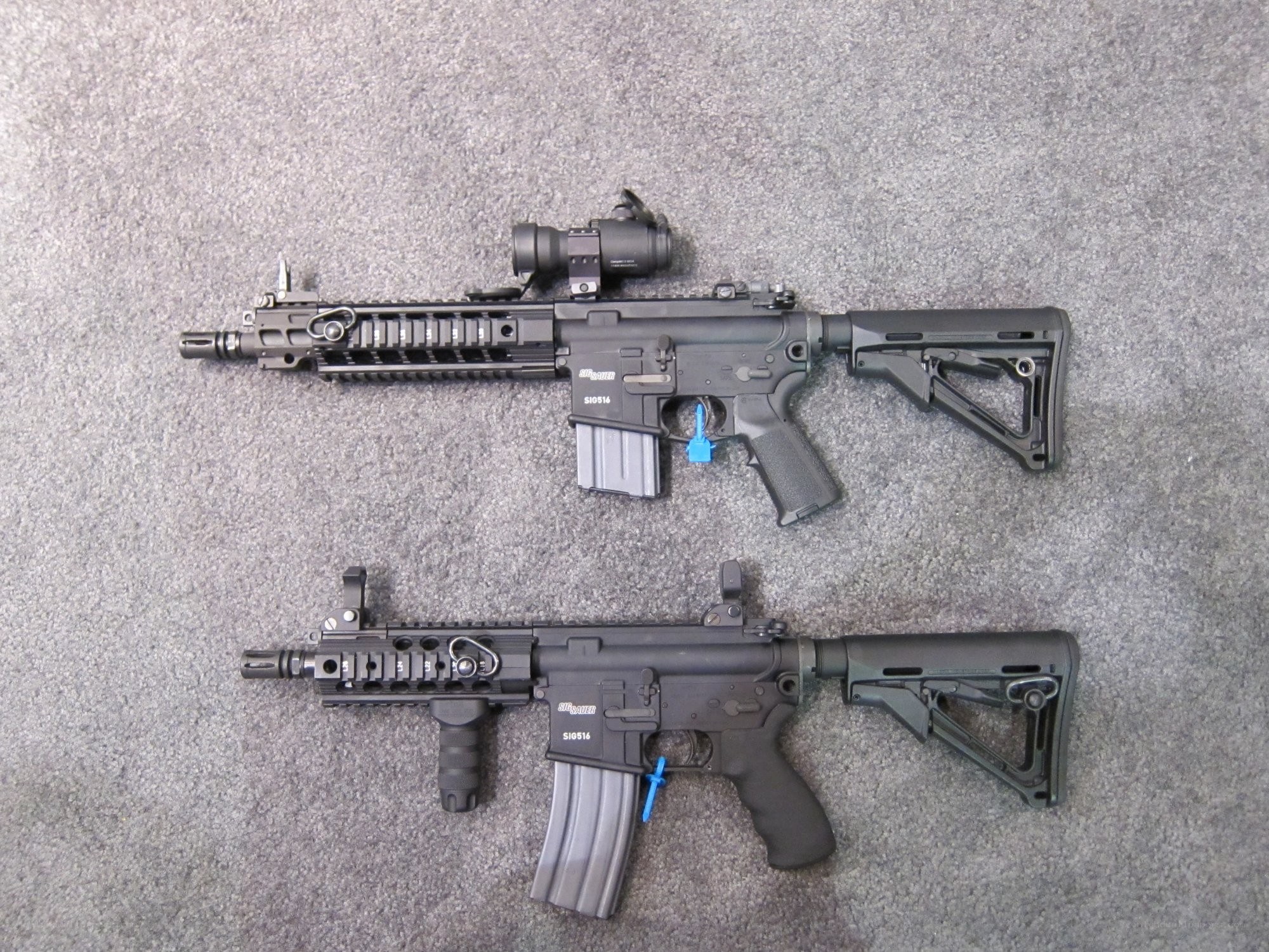 Two assault rifles on carpet
