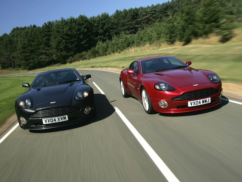 Two Aston Martin cars on a road
