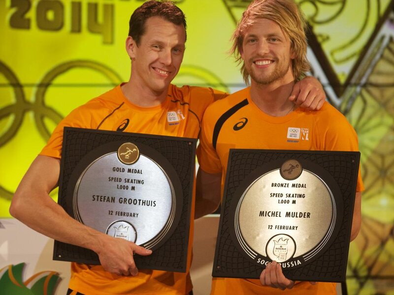 Two Athletes Holding Medals