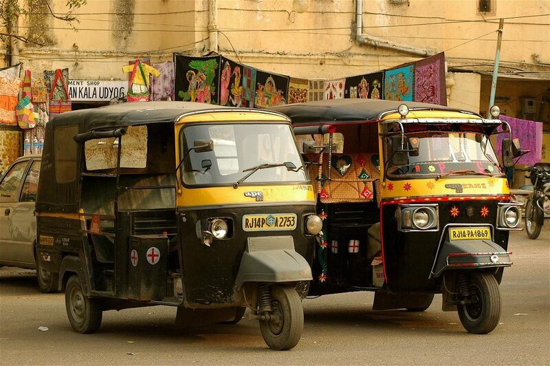 Two auto-rickshaws on a street