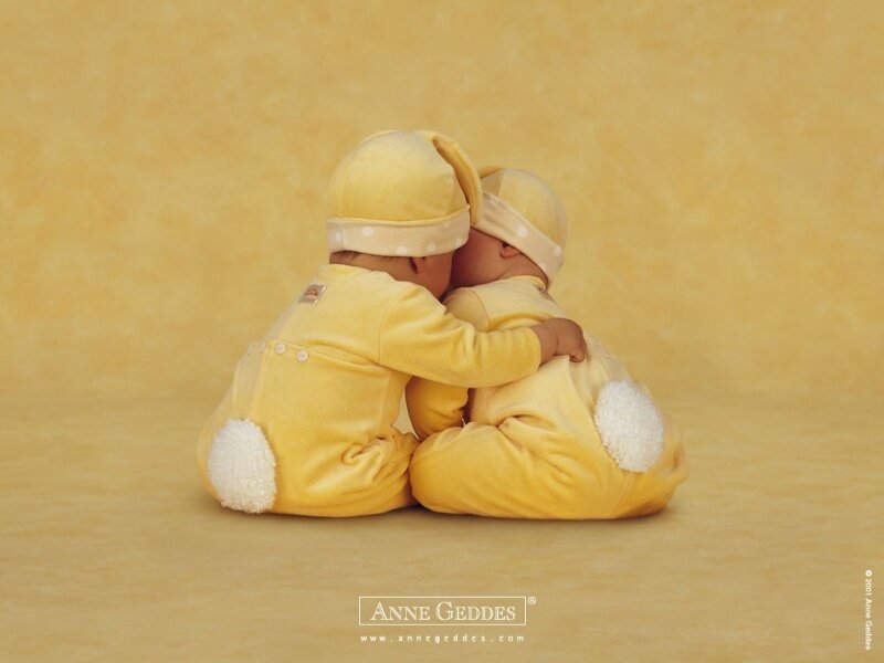two babies hugging in yellow