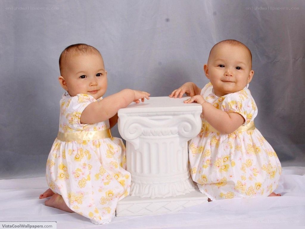 two babies in floral dresses