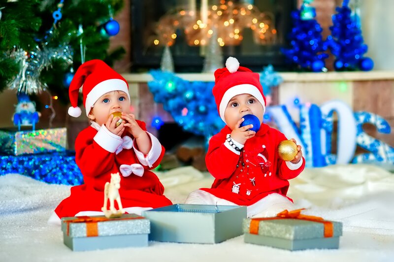 Two Babies in Santa Outfits
