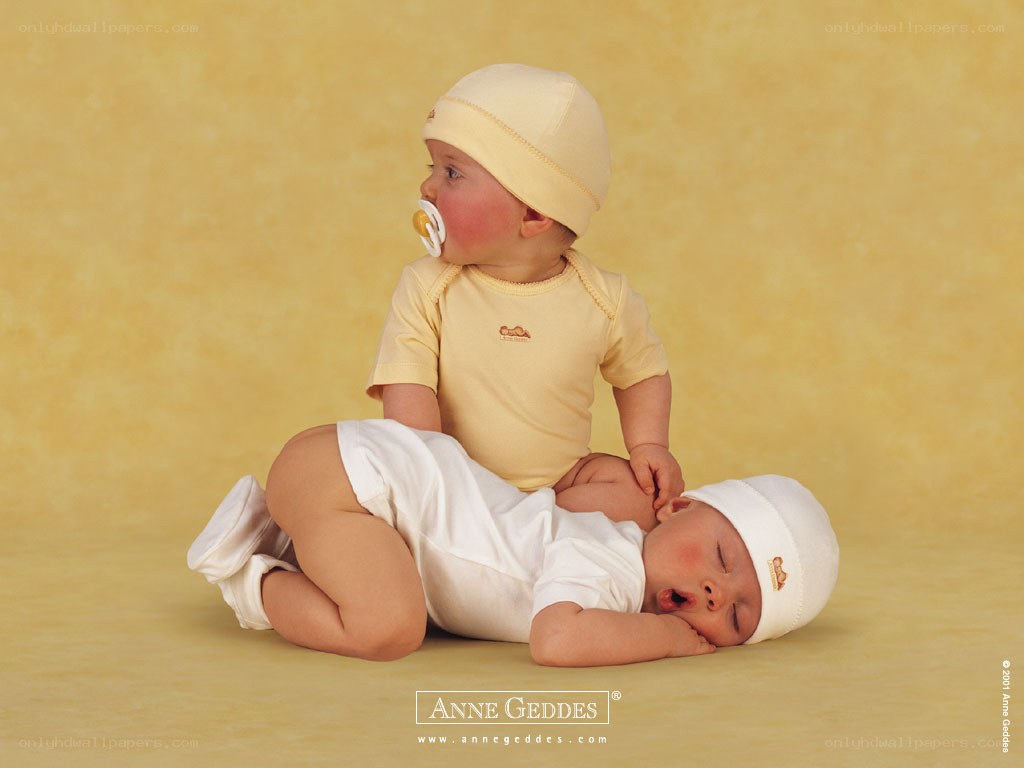 Two babies in yellow and white