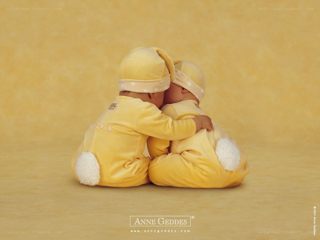 Two babies in yellow bunnies