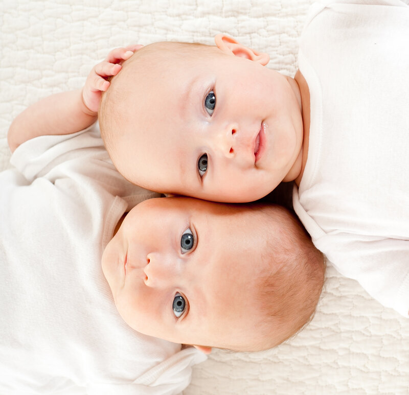 Two Babies Lying Down — White