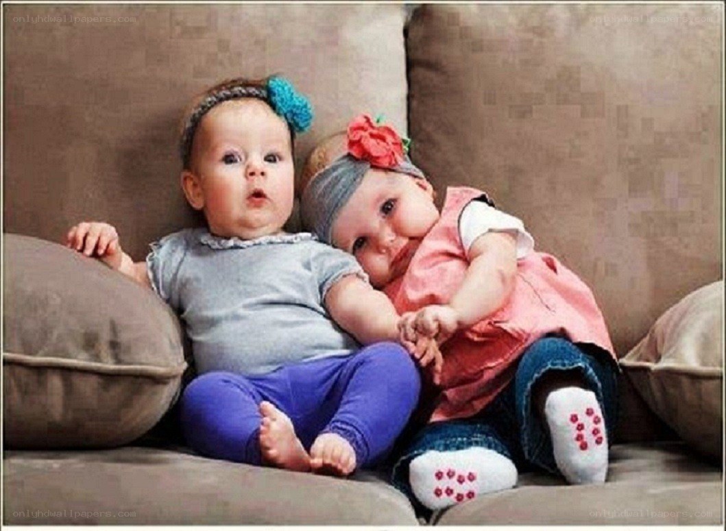 two babies on a couch