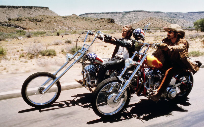 Two bikers on chopper motorcycles