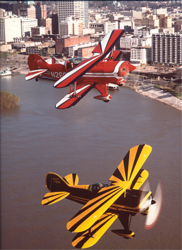 Two biplanes over a city