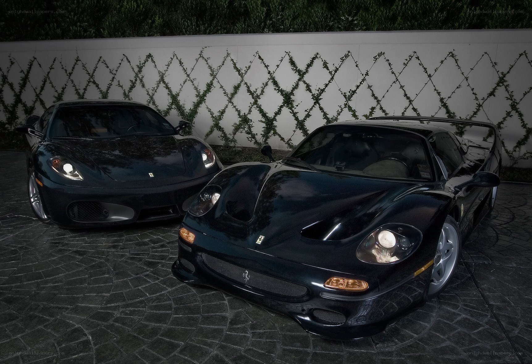 Two black Ferraris parked