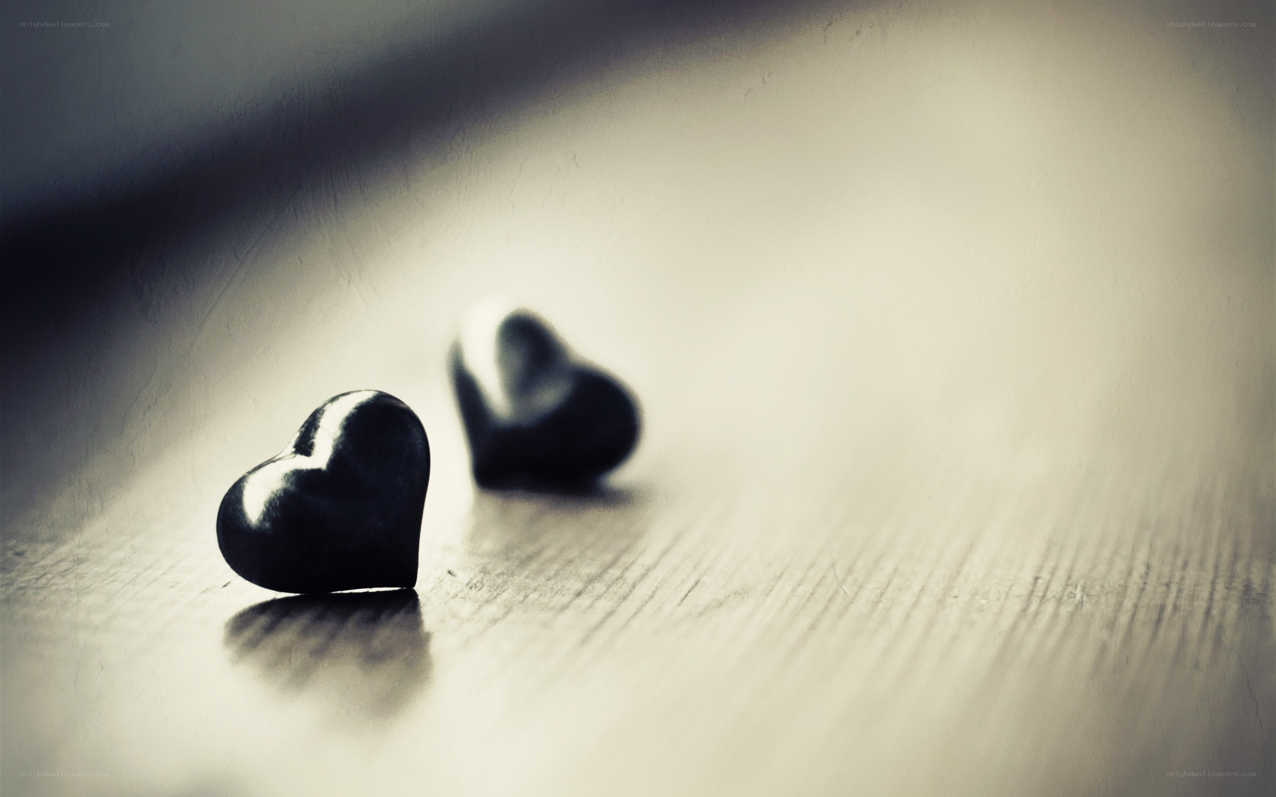 two black hearts on wood