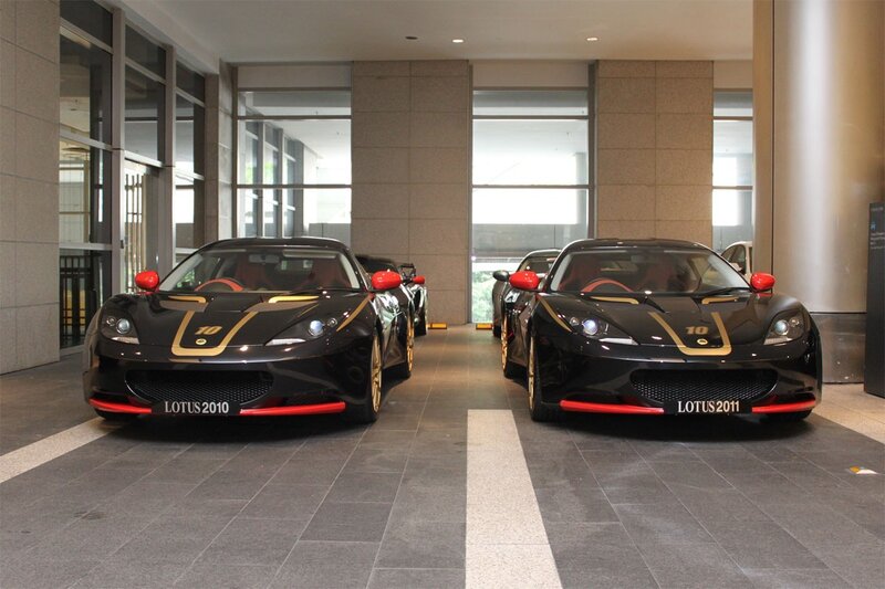 Two black Lotus cars in showroom