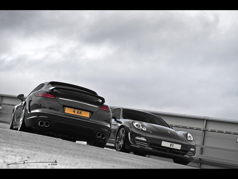 Two black Porsches on a ramp