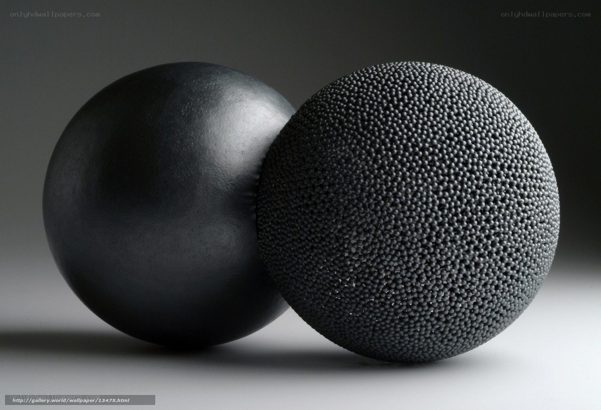 Two black spheres, one smooth one textured