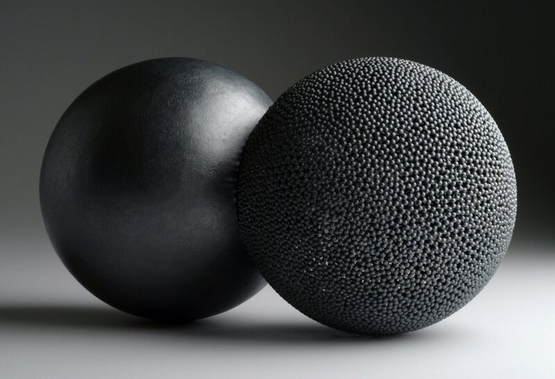 Two black spheres with different textures
