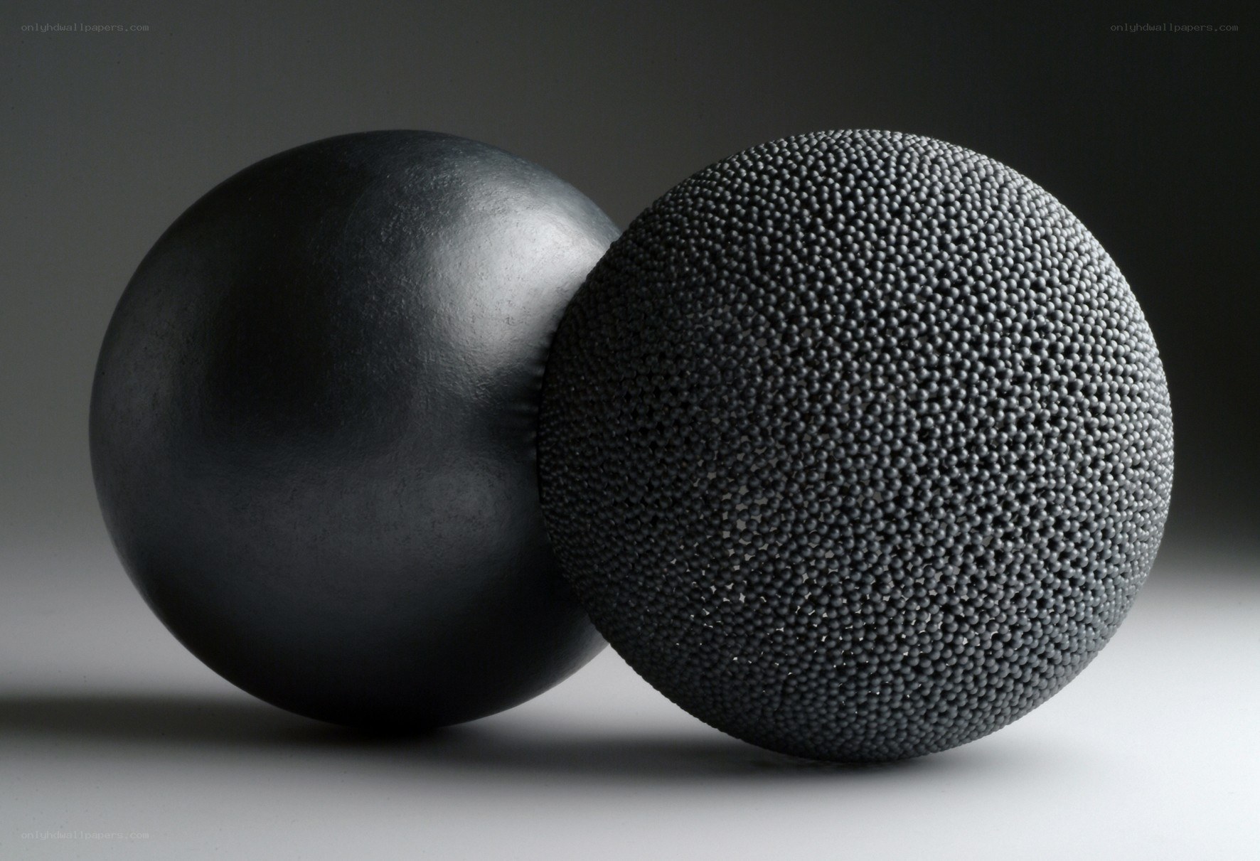 Two black spheres with different textures