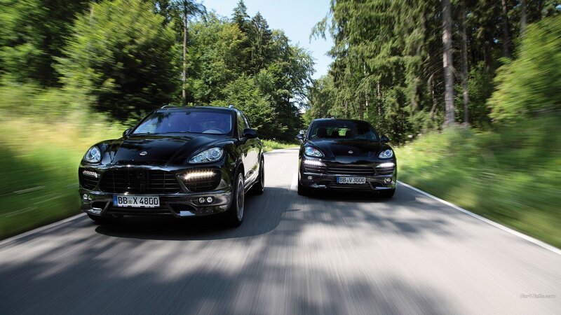Two Black SUVs on Road