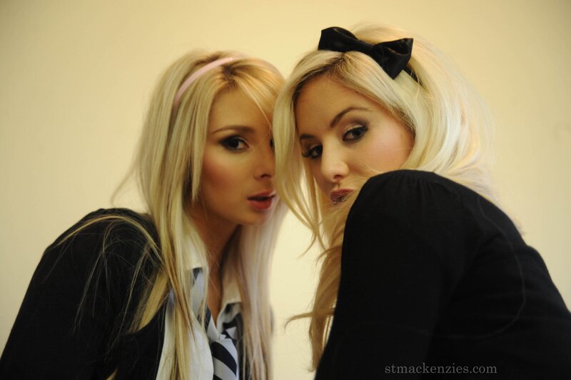 Two blonde women posing