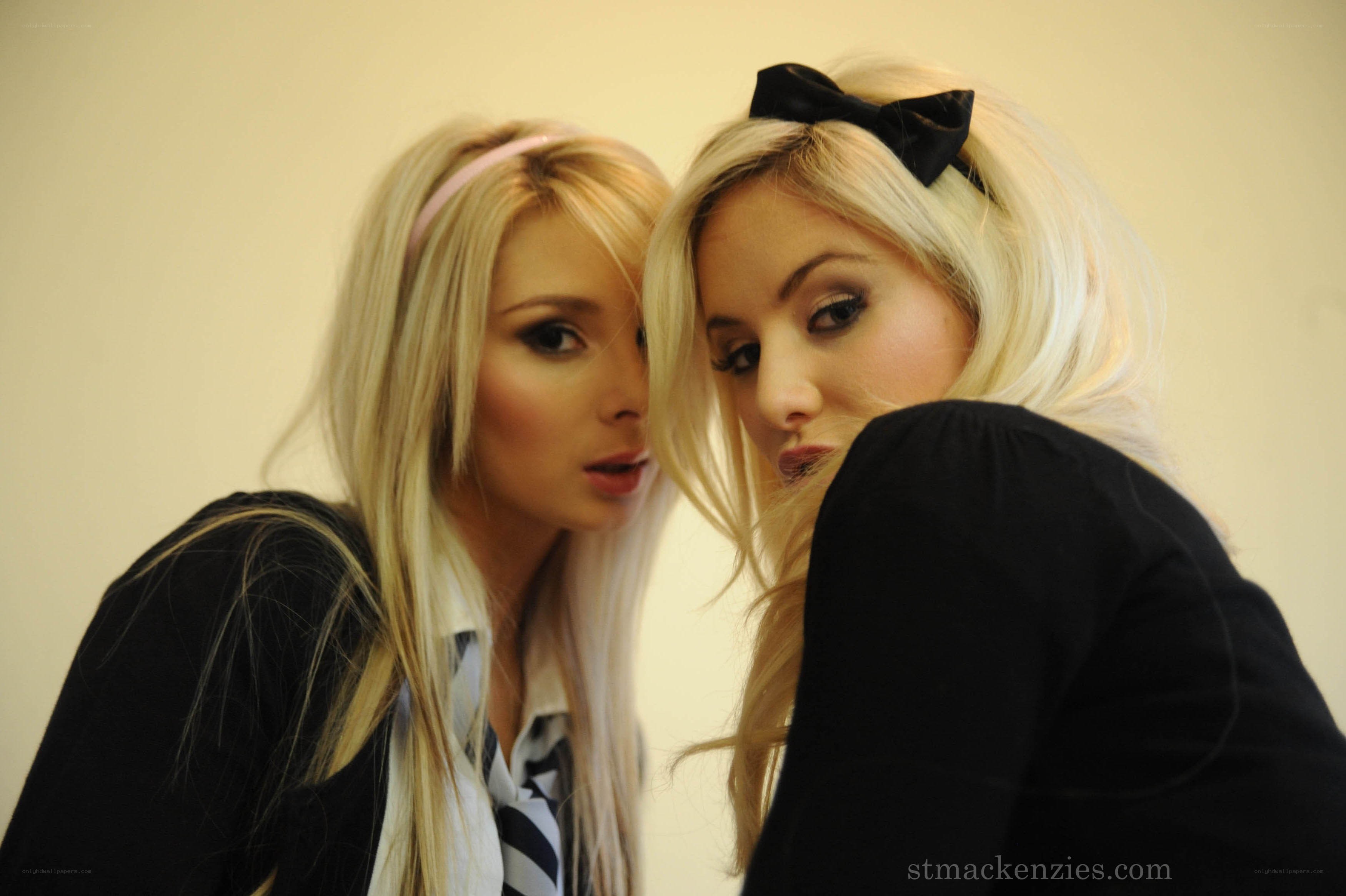 Two blonde women posing