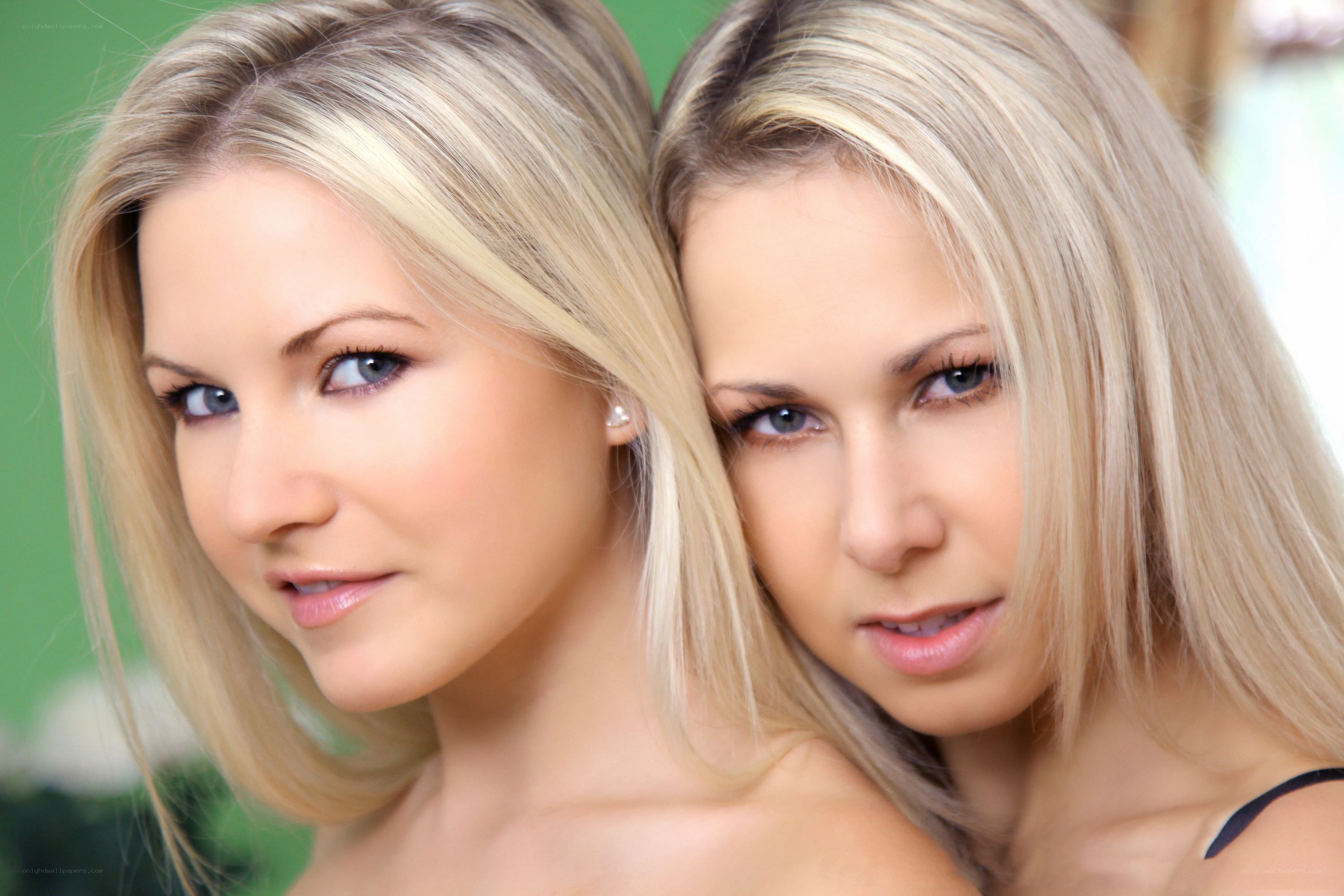 two blonde women posing together