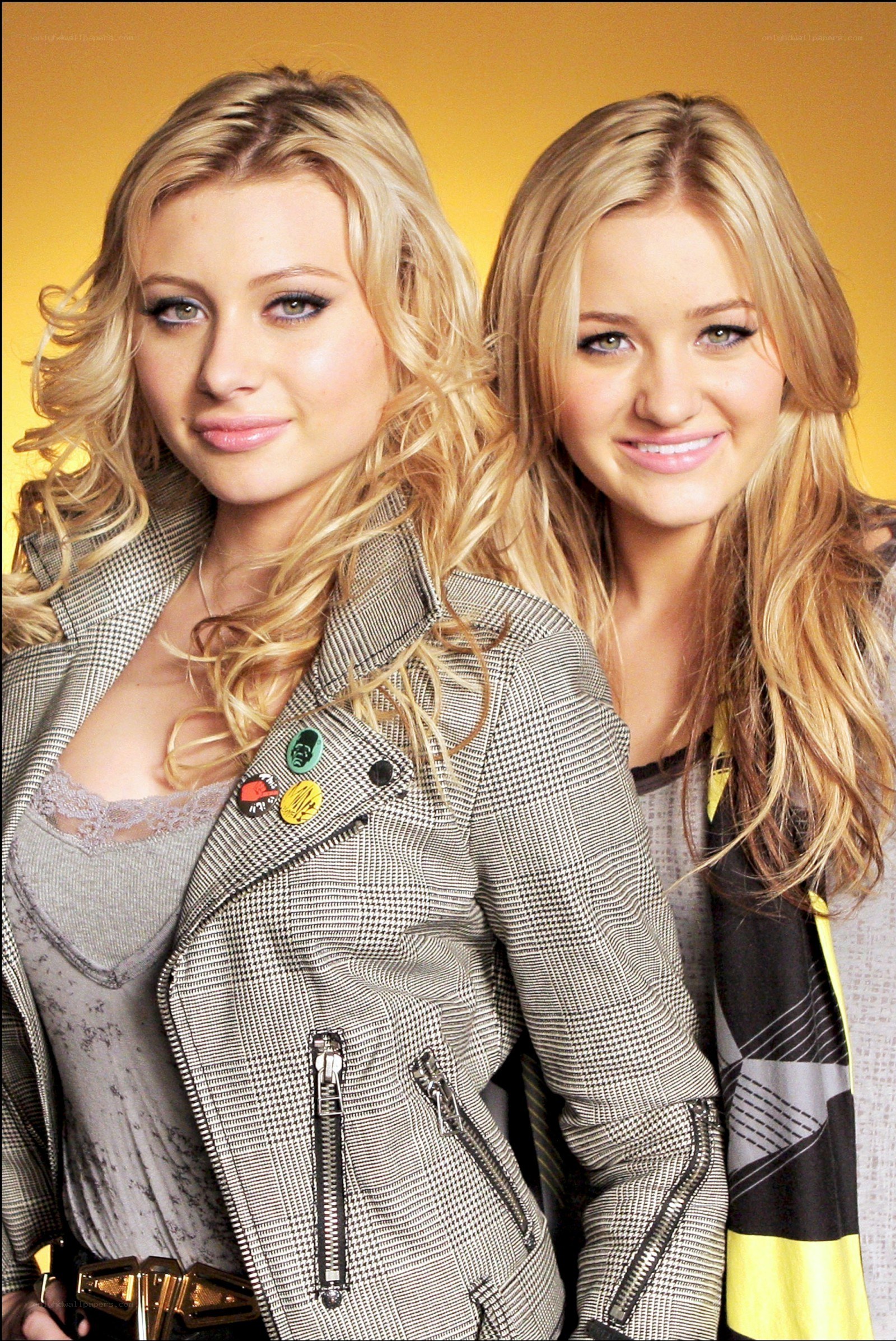 two blonde women posing together