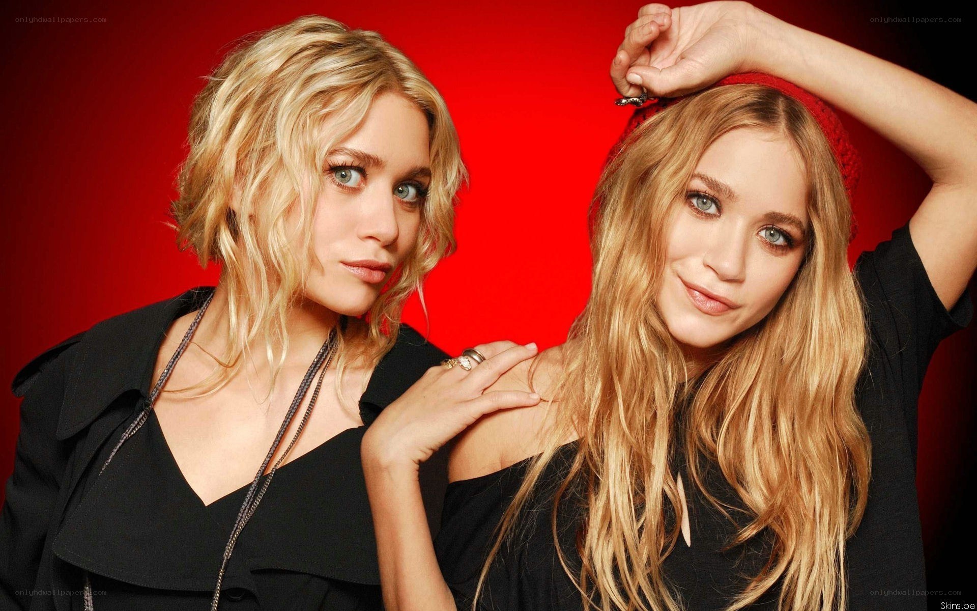 two blonde women posing together