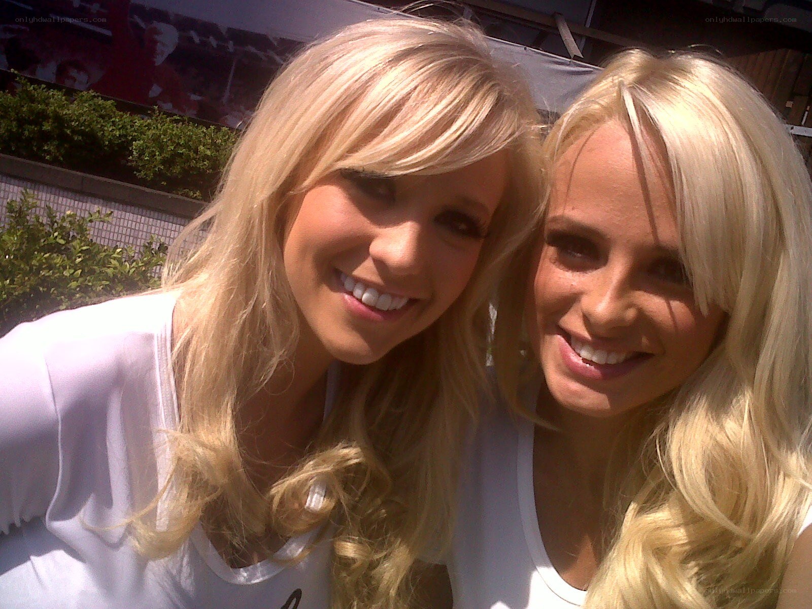 two blonde women smiling