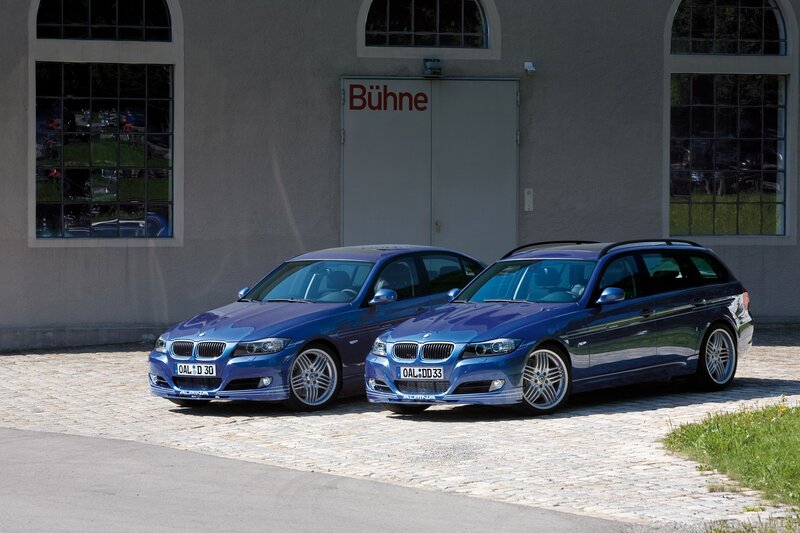 Two blue BMW cars parked