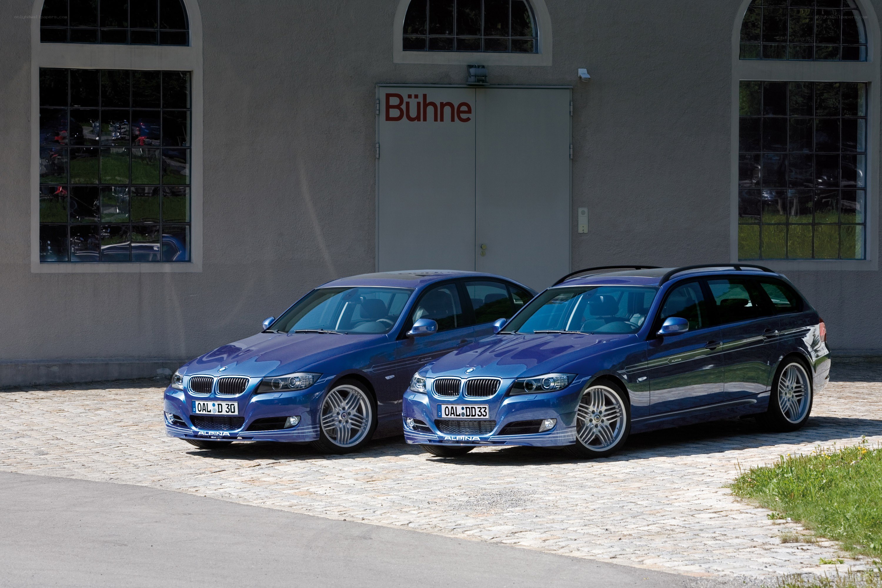 Two blue BMW cars parked