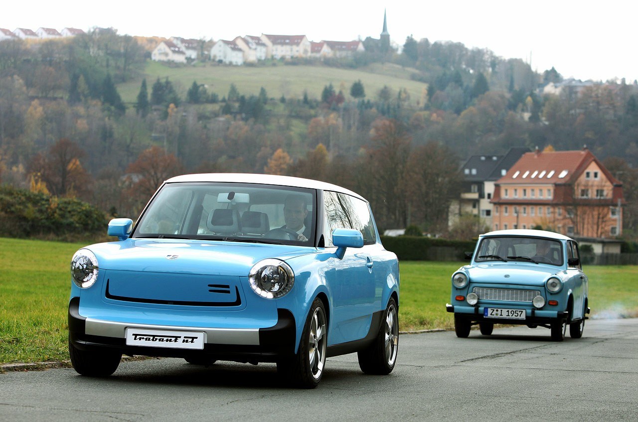 Two blue cars on a road