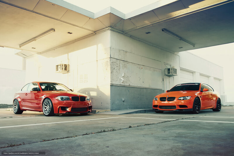Two BMW cars at a gas station