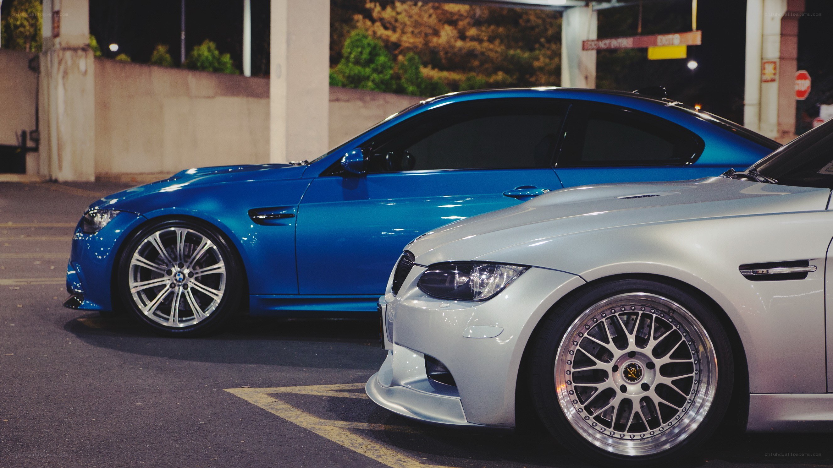 Two BMW cars at night