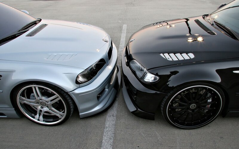 Two BMW cars facing each other