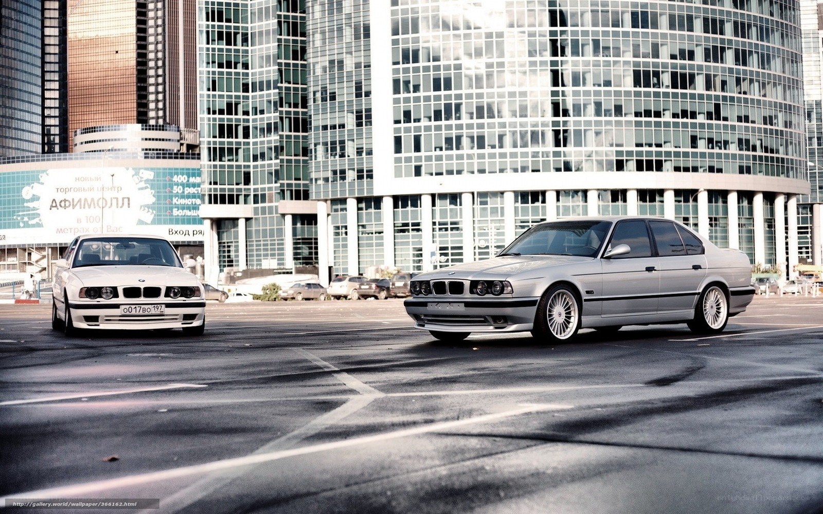 Two BMW cars in city