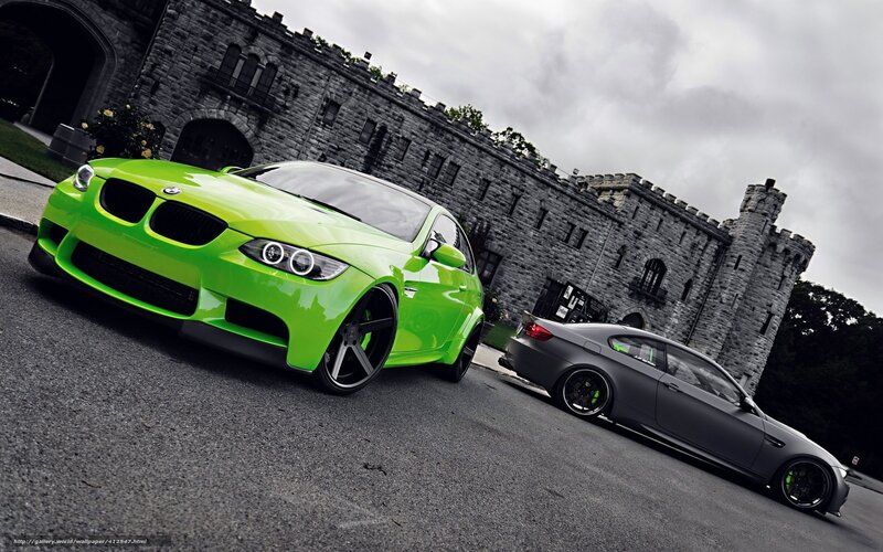 Two BMW cars in front of a castle