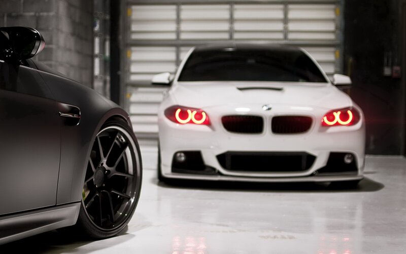 Two BMW Cars in Garage — White, Dramatic