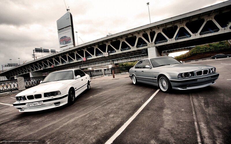 Two BMW cars on a bridge